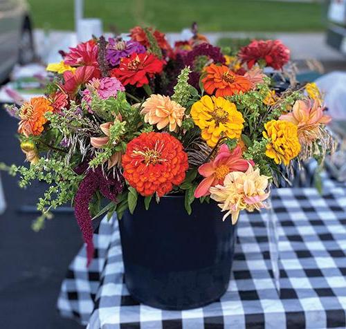 photo of colorful bouquet of fall flowers sitting on a table with a checkerboard tablecloth